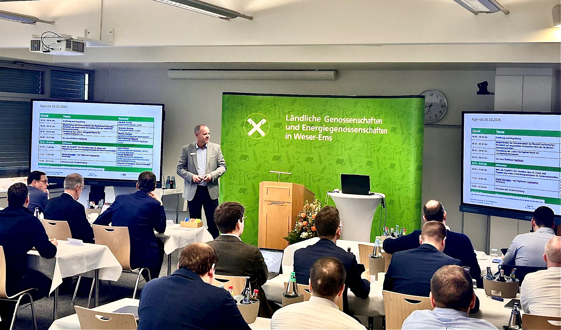 Teilnehmer lauschen dem Moderator der Tagung